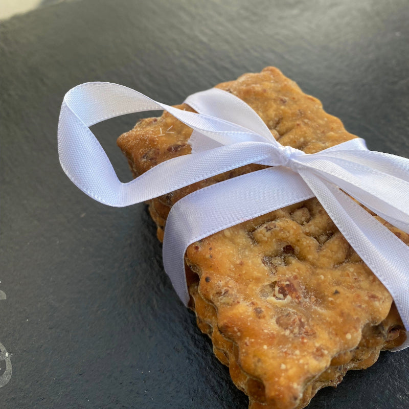 A pack of personalised beef meat biscuits, presented with a ribbon