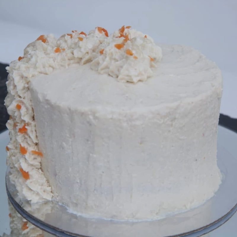 A chicken frosted meat cake for pets, garnished with chicken parfait swirls and fresh carrot