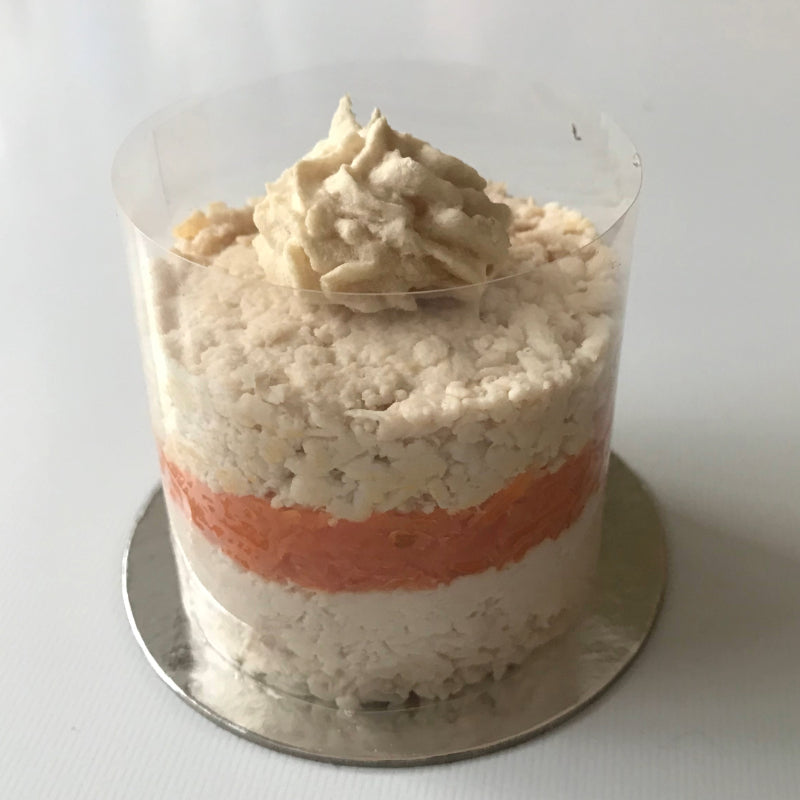 A butter baked chicken cupcake for pets, made from layers of chicken breast and carrot, topped with a chicken parfait swirl