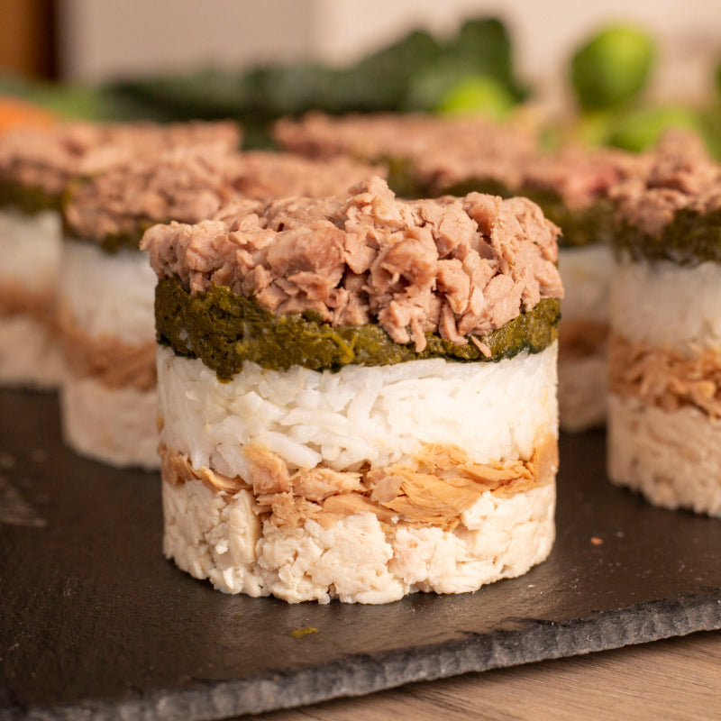 A meat cupcake for pets containing layers of chicken breast, spinach and rice