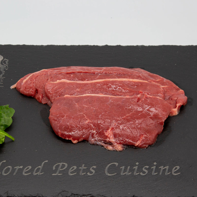 Raw steak on a chopping board