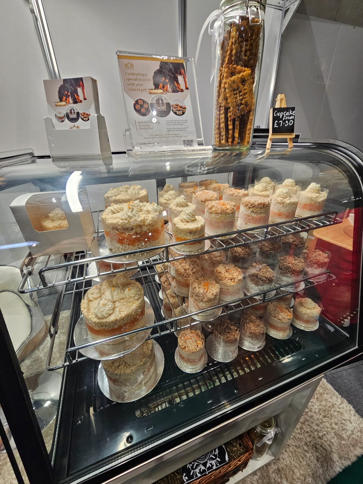 A cabinet of meat pet cakes of varying sizes